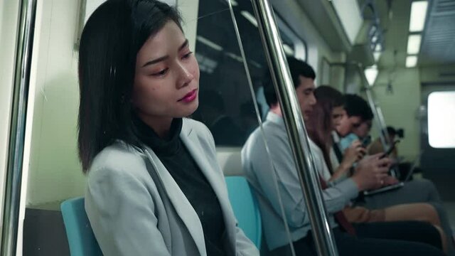  Asian woman sitting in the subway train. Public transport, she was tired and frustrated

