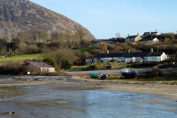 Trefor beach, Wales. Delightful landscape with small houses at a sandy shore.  A secluded bay on the beautiful Llyn Peninsula.  Sunny, bright day with peaceful tranquil countryside.
