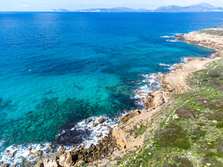 Fototapeta premium Blue sea in Alghero shore with Capo Caccia on the background