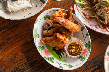 Top view of Thai style deep Fired chicken wings with salt and Spicy Dipping Sauce at Ko Kret Island , Nonthaburi province Thailand