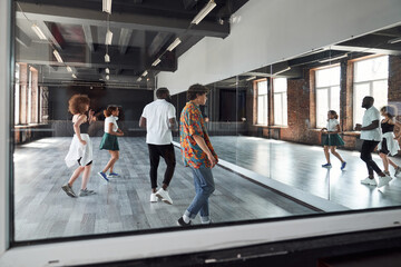 Fototapeta premium Happy young people during dancing class indoors