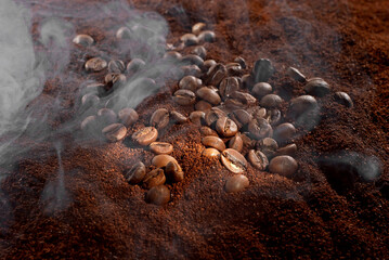 Coffee beans close up. Texture of brown coffee beans in smoke. Ground and coarse coffee. Contrasting dramatic light as an artistic effect.