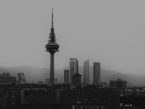 Imagen en blanco y negro del skyline de Madrid, con las cuatro torres de la Castellana y Torre Espa&ntilde;a (El Pirul&iacute;) y la sierra al fondo