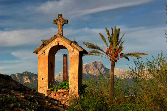 Rural chapel and palm tree with distant view of Puig Major, Mallorca, Spain