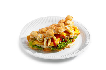 Bubble waffle with fried chicken, fries, cheese, tomato and salad