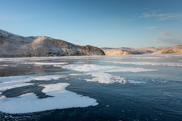 Frozen Lake Baikal. Blue ice, winter landscape.