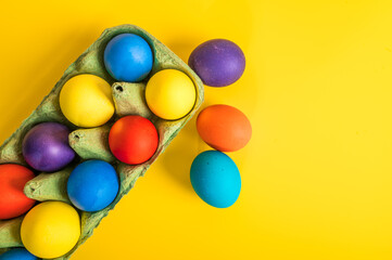 Multi-colored Easter eggs in an egg tray