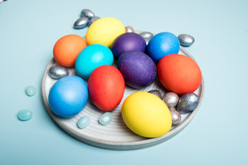 Coloured decorated easter eggs on a blue background