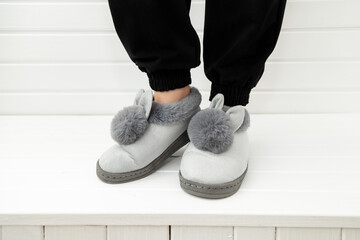 gray soft slippers rabbits on white background home comfort concept