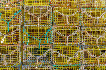 Close-up of bright yellow lobster pots in fishing village.