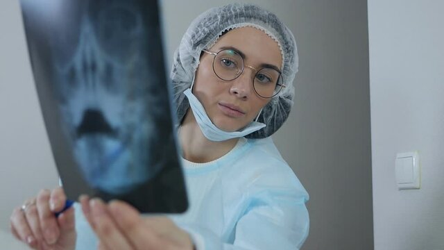 Young female doctor looking at an x-ray of a patient
