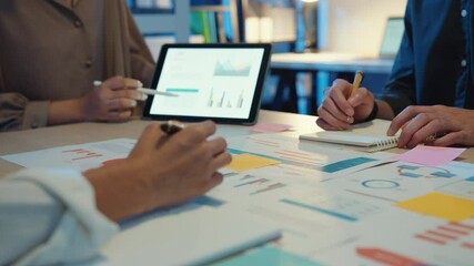 Close-up asia business people meeting plan analysis statistics brainstorm and header of team hold tablet pointing graph chart and employee take note. Finance strategy statistics success concept. - Powered by Adobe