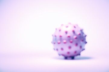 Blurred concept image of the coronavirus on the white background, tinted in light pink