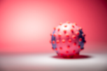 Blurred concept image of the coronavirus on the pink background