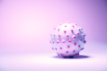 Blurred concept image of the coronavirus on the pink background, tinted in light pink