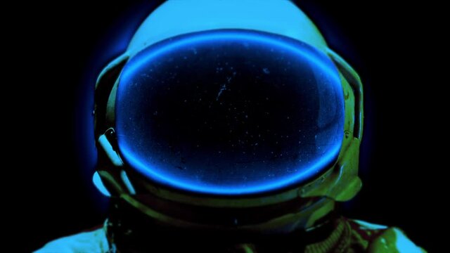 Space Astronaut Fantastic Scene In Blue Neon. Explorer Lost In Space Flying Close Up His Helmet Towards To Camera