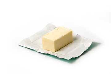 Traditional butter block unwrapped for use as a baking ingredient isolated on white background