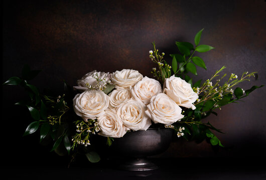 Bouquet of ivory roses on deep rust 