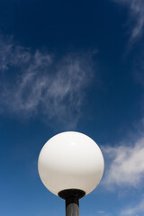 modern globe white light with blue sky background and white clouds
