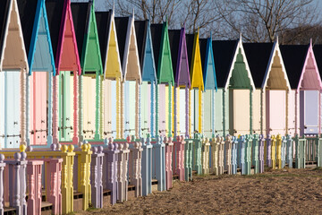 Fototapeta premium Parade of colourful beach huts on Mersea Island in Essex