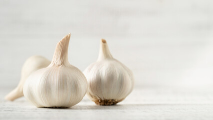 Three Garlic Bulbs on a White Background.
