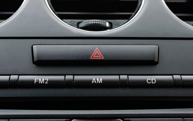emergency button on black car dashboard