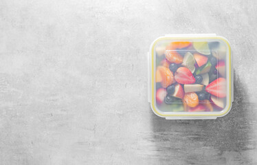 Packed fruit salad in plastic box. Healthy meal to go