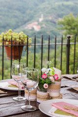 Wedding table setting against the backdrop of a mountain landscape.