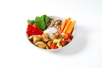 Bowl of beans, pineapple salsa, grilled chicken fillet, carrots and peppers
