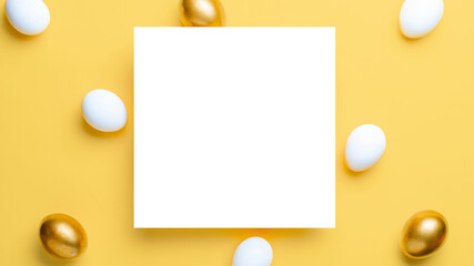 Easter background yellow. Golden, white colour egg on pastel yellow background in Happy Easter decoration. Flat lay, top view.