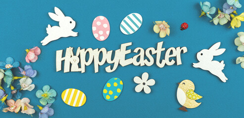Happy Easter banner on a pastel background, flat lay and top view compisition with wooden text and holiday decoration