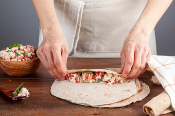 Sikma is a traditional Turkish wrap in mediterranean coast of silifke, mersin. Flat bread known as bazlama is laid and filled with mixture of cheese, tomato and herbs and rolled around tightly.
