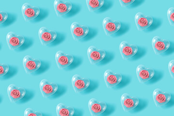 Pattern made with pink roses in transparent heart shaped balloons. Flower wallpaper layout. Minimal flat lay background concept.