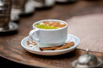 coffee, sahlep, white cup Sahlep, Turkey's milk hot drink with cinnamon powder and antes Fist of...