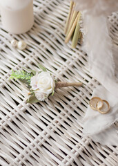 white groom boutonniere and two gold rings in one. wedding theme	