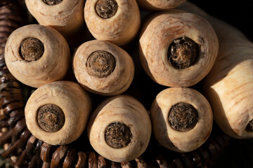 Parsnips are in a wicker basket and are photographed from above