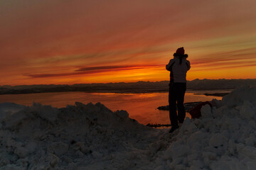 silhouette of a person standing on the top of the mountain