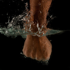 Angry mans fist punching water. Human power energy in water