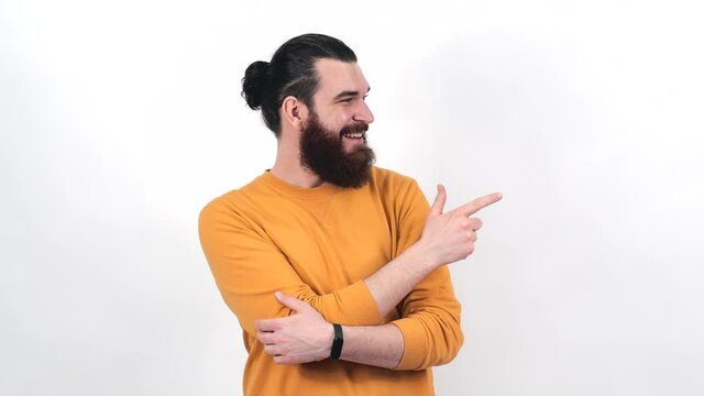 Footage of handsome bearded man pointing away