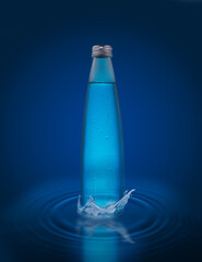 a glass bottle of crystal clear water on a blue background stands in the water with a splash.