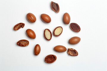 Argan seeds isolated on a white background. Argan oil nuts with plant. Cosmetics and natural oils background