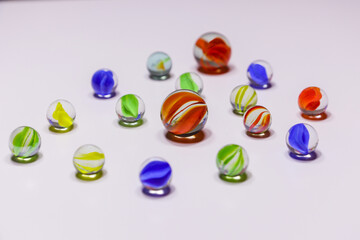 Fototapeta premium Bunch of colorful glass marbles on the white background 
