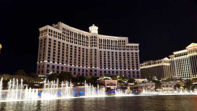 Fountains of Bellagio shoot water in the air at Night