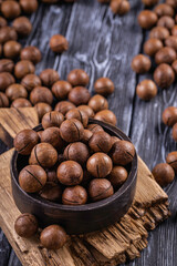Macadamia nuts are cracked and baked to taste extremely delicious. Toasted organic healthy food.