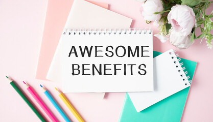 Awesome Benefits text written on a notebook with pencils