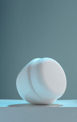 Vertical shot of Laying lotion cream container on white platform with copy space