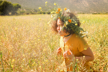Girl with wreath on head in the field.