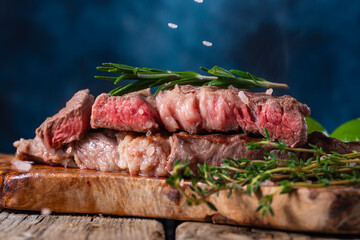 a cooked piece of beef, the steak is salted, the pieces of salt are frozen in motion. with vegetables