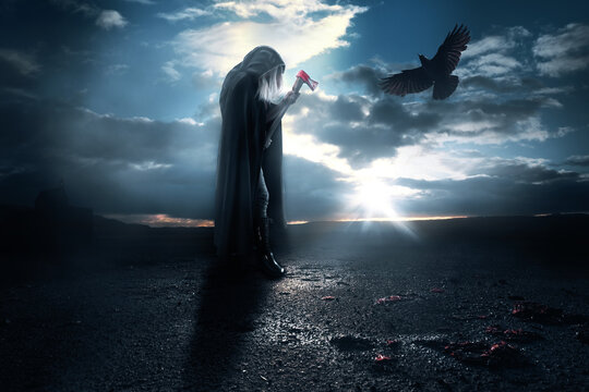 Halloween creepy - dark death figure with hood and battle axe with blood - companion raven and a chapel in the background. Witch murder death.