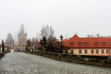 Charles bridge in the early morning abandoned with fog